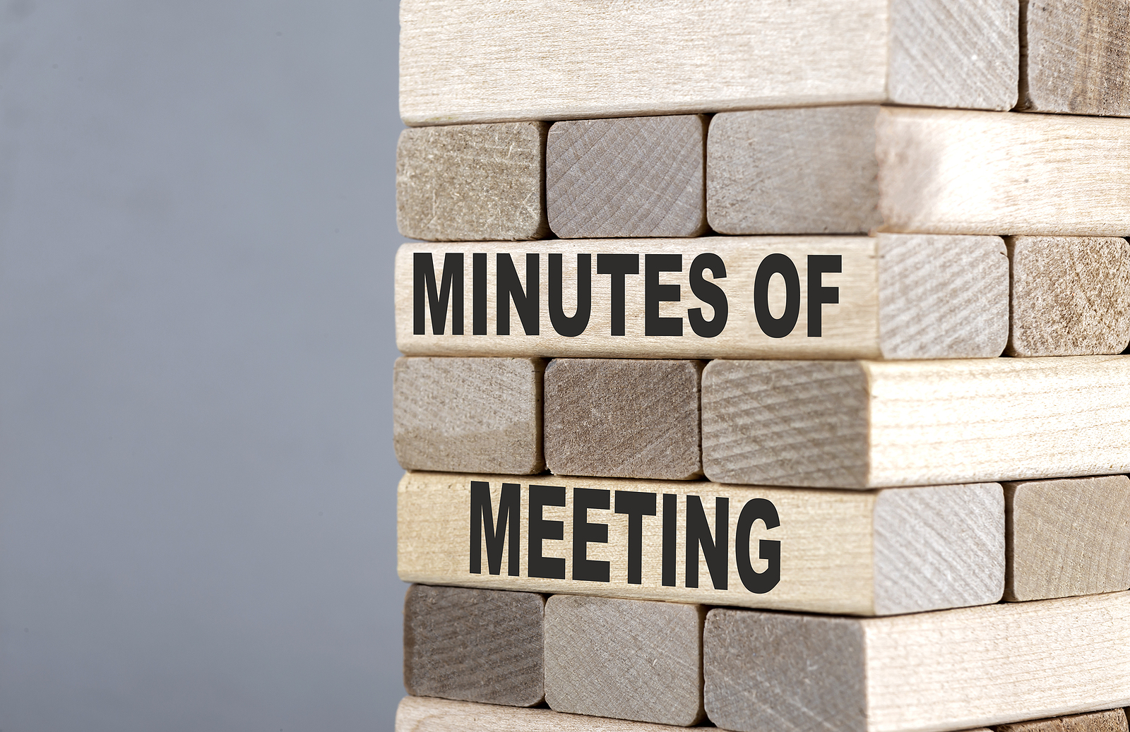 The text on wooden blocks MINUTES OF THE MEETING